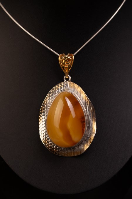 Silver pendant with gold plating and natural Baltic amber